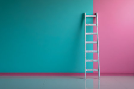 A rustic wooden step ladder stands against a bold, two-tone wall blending smooth teal and blush pink, fostering a sleek, contemporary vibe in a minimalist setting.の写真素材