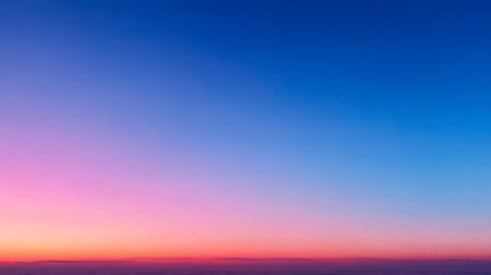 A tranquil horizon bathed in gentle twilight, where lavender and amber seamlessly merge into a deep navy sky, creating a peaceful and awe-inspiring sunset scene.の写真素材