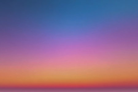 A tranquil sky blends gentle shades of dusk, with rich blue fading into lively purple and soft orange, evoking peace and ideal for artistic or creative projects.の写真素材