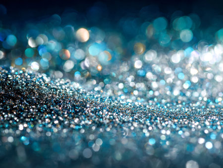 Vibrant blue and silver specks shimmer softly, forming a captivating glow that evokes dreamy, mystical depths in a luminous, abstract backdrop.の写真素材