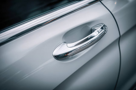 A polished chrome grip accentuates the pristine white exterior, highlighting contemporary craftsmanship and sophisticated curves that convey exclusivity.の写真素材