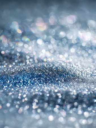 A luminous blend of metallic silver and icy blue flecks dance across a glowing backdrop, accented by gentle bokeh orbs that evoke a poetic, enchanting mood.の写真素材