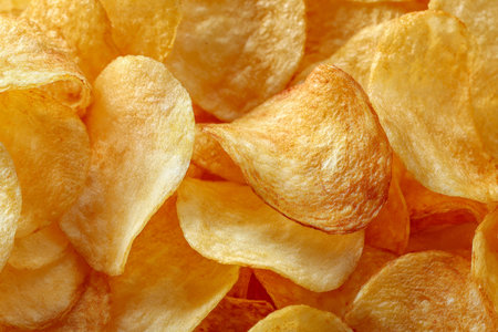 A mound of perfectly baked, golden-brown potato slices highlighting their crispiness and alluring...