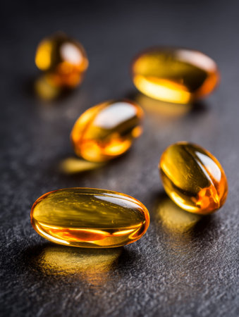 Luminous golden capsules with mirror-like finishes lay randomly on a rugged dark surface, conveying...