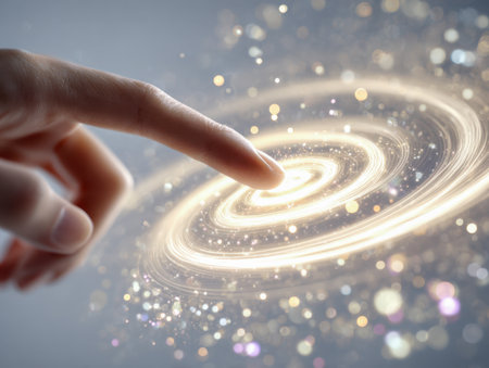 A human fingertip caresses a radiant whirlpool of shimmering gold sparks, evoking a sense of wonder and enchantment within a sleek, high-tech digital realm.の写真素材