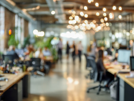 Bright, spacious workspace featuring diverse employees at shared desks and moving through a vibrant, plant-filled environment that fosters teamwork and creativity naの写真素材