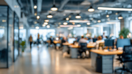 Bright, contemporary workspace featuring teams engaging at shared desks under exposed industrial ceiling lights, fostering creativity and teamwork in a stylish settiの写真素材