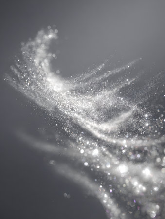 Sparkling metallic dots move in elegant spiral motions, casting a luminous glow that evokes a sense of delicate movement and celestial shimmer.の写真素材
