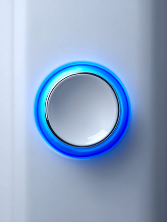 A contemporary metallic dial emits a vivid blue illumination, resting on a smooth white background, embodying innovative interface technology for streamlined deviceの写真素材