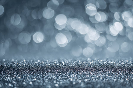 Joyful celebration ambiance featuring a luminous silver sparkle surface, complemented by soft, out-of-focus lights perfect for sophisticated festivities.の写真素材