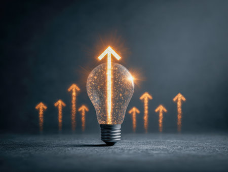 A luminous bulb featuring a bright upward arrow at its core, surrounded by several ascending lines, representing progress and inventive energy amid a dark backdrop.の写真素材