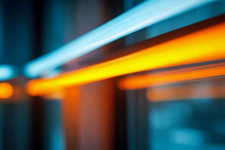 Vibrant streaks of azure and tangerine shimmer across a glassy surface, evoking a dynamic city nightlife ambiance filled with energy and contemporary flair.の写真素材