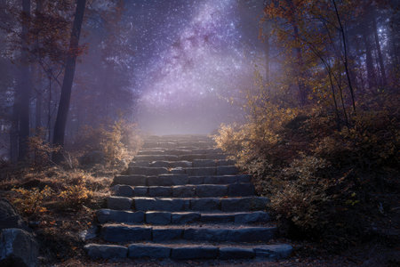 A hidden stone staircase winds through a dark forest, illuminated by luminous fall leaves beneath a vibrant galaxy filled with shimmering stars and celestial beams.の写真素材