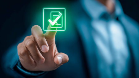 A professional male engages with a high-tech virtual interface, tapping a luminous approval symbol to streamline tasks and enhance workplace efficiency.の写真素材