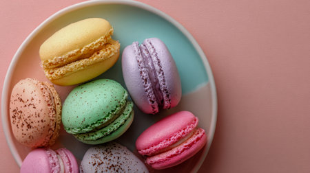 Vibrant French macarons in various flavors are artfully displayed on a delicate pastel blue and...