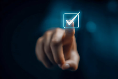 A hand interacts with a luminous symbol on a sleek, transparent digital interface, evoking a sense of confirmation amid a moody, out-of-focus backdrop.の写真素材