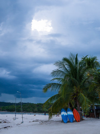 Kayak on the beach with the sea and rain clouds viewの写真素材