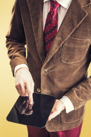 Old fashioned suit wearing business man using modern tabletの写真素材