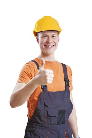 Construction worker giving thumbs up symbol, isolated on whiteの写真素材