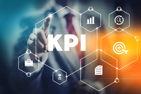 KPI business man selecting word KPI meaning key performance indicator. Metrics for company and worker management and success.の写真素材
