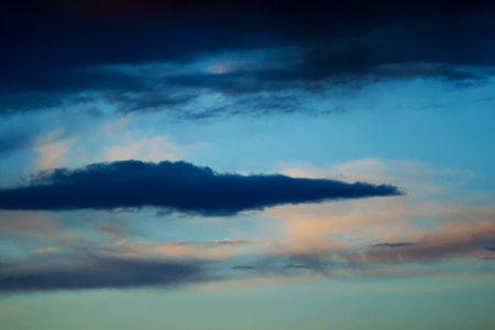 Majestic sky clouds,sunset, and a storm rising の写真素材