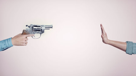 Gun pointed to a hand with stop sign. Stop shootings and protest concept. This is a 3d render...