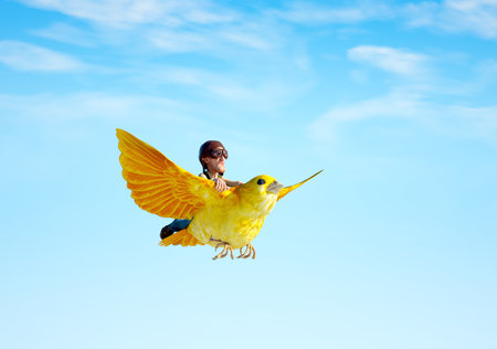 Man flying on a yellow bird. Freedom concept. This is a 3d render illustrationの写真素材