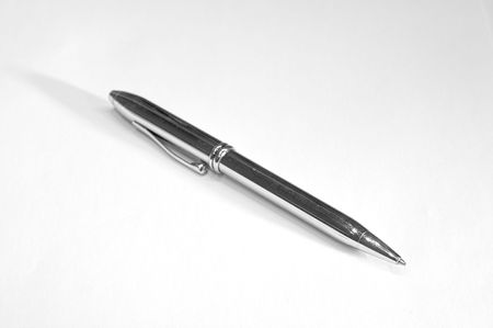 Metal ballpoint pen on a white background; focused on pen tipの写真素材
