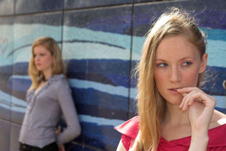 two pretty adult girls have fallen outの写真素材