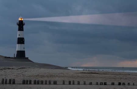 Vuurtoren Breskens lighthouse in the Netherlands shining in the night.の写真素材