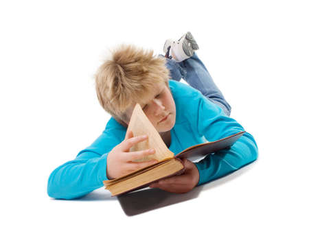 Teenager boy reading an old book; isolated on whiteの写真素材