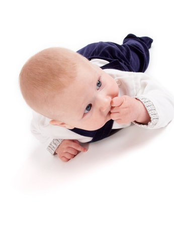 cute little baby crawling; isolated on whiteの写真素材