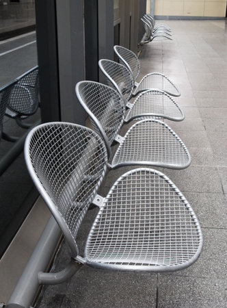 raw of metal chairs in a railway station の写真素材