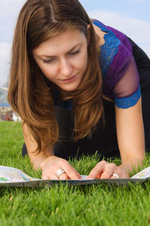 young female tourist finding her way on the mapの写真素材