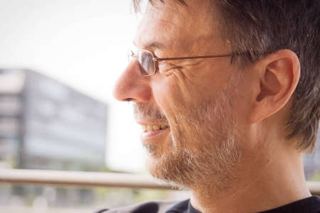 Happy mature man photographed outdoors in a sunny dayの写真素材