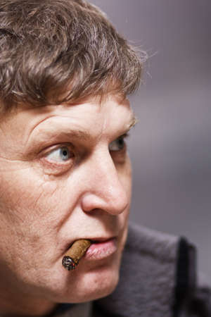 Mature man with cigar, unhappy expressionの写真素材