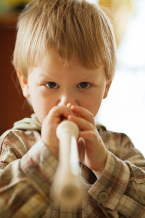 Toddler boy playing fluteの写真素材