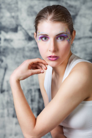portrait of a pretty young woman with face art