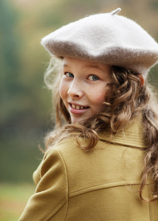 Portrait of blond teenager girl in grey beret in an autumn parkの写真素材