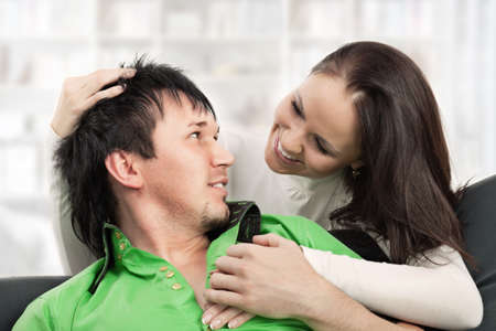 Happy young man and woman embracing and looking at each otherの写真素材
