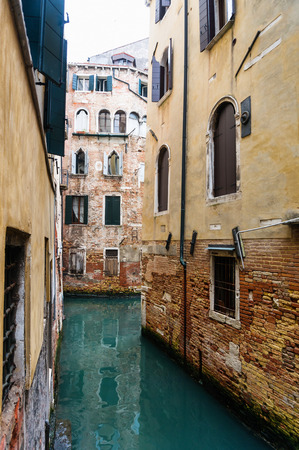 Narrow Venetian canal in a sunny day - Venice, Italyの写真素材