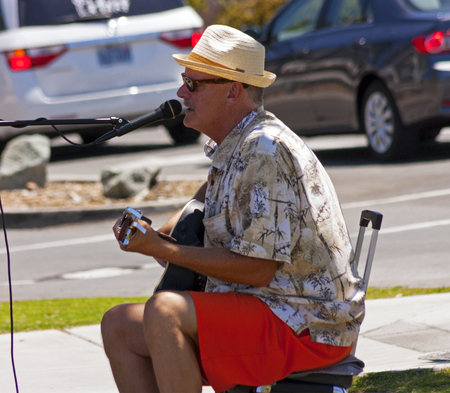 SAN DIEGO,USA - MAY 02,2014 :An unidentified old musician playing for money in the streets of  historic center of San Diego.City was founded here in 1769.のeditorial素材