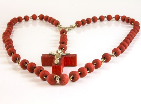 Red color heart of chaine of beads with crocifixの写真素材
