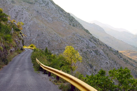 photo of narrow winding road in the mountainsの写真素材