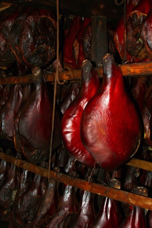 delicious smoked pork hanging in the smokehouseの写真素材