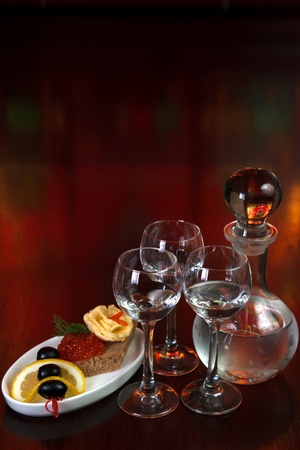 three glasses of vodka and a bottleの写真素材
