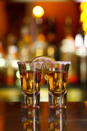 two shots of tequila with lime and saltの写真素材