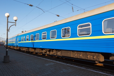 passenger rail car blue color on an empty platform in the early morningの写真素材