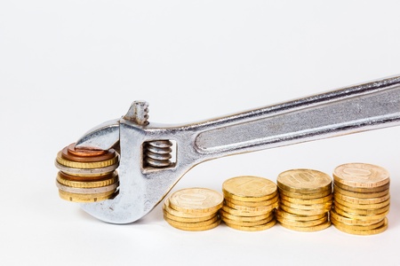 wrench and coins on white backgroundの写真素材