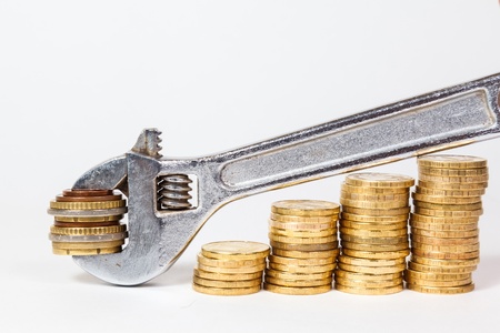 wrench and coins on white backgroundの写真素材
